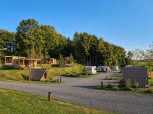 a group of camping sites in a field with trees at Forest Camping Resort Blaguš in Sveti Jurij ob Ščavnici