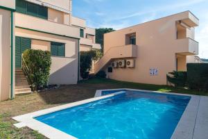 a swimming pool in front of a house at Costabravaforrent Pedró in L'Escala