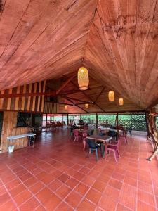 a large room with tables and chairs in a building at Finca Agroturística La pradera in Acacías