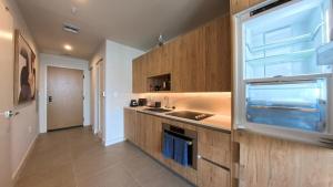 a kitchen with wooden cabinets and a sink and a window at C5103 Outstanding Studio in the Heart of Downtown in Miami