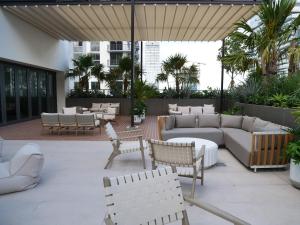 an outdoor patio with couches and tables and chairs at C5103 Outstanding Studio in the Heart of Downtown in Miami