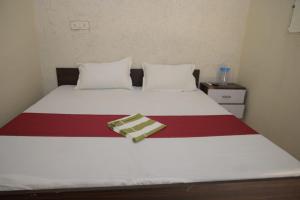 a bed with two pillows and a blanket on it at Hotel dream sagar in Sāgar