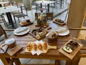 a wooden table with plates of food on it at Forest Camping Resort Blaguš in Sveti Jurij ob Ščavnici