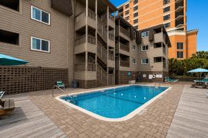 a swimming pool in front of a apartment building at Ocean Forest Colony in Myrtle Beach