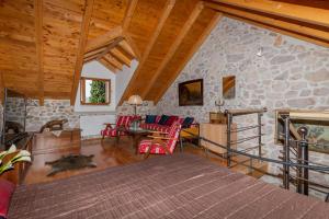 a living room with red chairs and a stone wall at Luxury Resort Dobri Dida in Imotski +80 photos