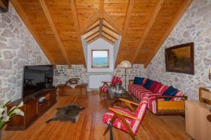 a living room with a couch and a tv at Luxury Resort Dobri Dida in Imotski
