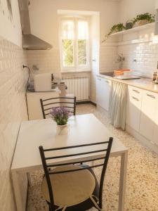 a kitchen with a table and chairs in a room at La Casetta in Genoa