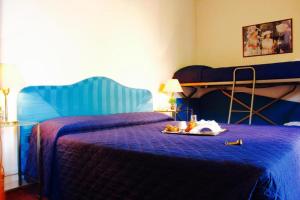 a bedroom with a blue bed with a bunk bed at Arcangelo Meublè in Rimini