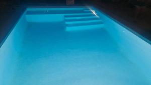 a bath tub filled with blue water with stairs at Bon Repos 2 in Torroella de Montgrí