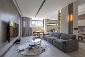 a living room with a couch and a table at 晴井villa in Huxi
