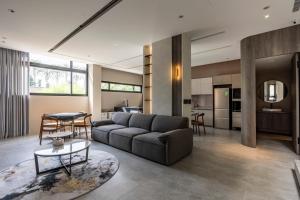a living room with a couch and a table at 晴井villa in Huxi