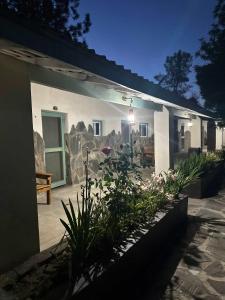 a white building with plants in front of it at room #2 Rancho Meling in Camalú