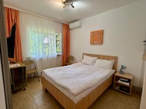 a bedroom with a bed and a window at Casa Double M, Vama Veche in Vama Veche +92 photos