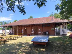 a building with a ping pong table in front of it at Szentkút Kemping Vasvár in Vasvár