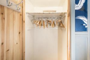 a closet with a rack of hangers at Daiches Braes Brunstane Portobello in Edinburgh