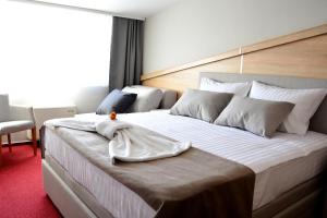 Postel nebo postele na pokoji v ubytování Hotel Dolenjc