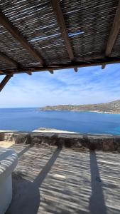 a view of a body of water from a porch at The Rock View Apartment in Mikonos