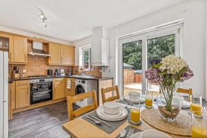 a kitchen with a table with a vase of flowers on it at Contractor Base Parking 4 Beds Fast Wi-Fi in Bolton upon Dearne