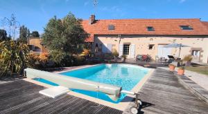 a swimming pool in front of a house at Entre terre et baie à 15 mn du Mont-Saint-Michel in Pontaubault