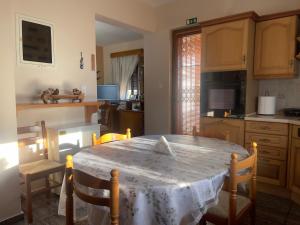 a kitchen with a table with a white table cloth on it at VILLA ANTONIS in Kos +39 photos