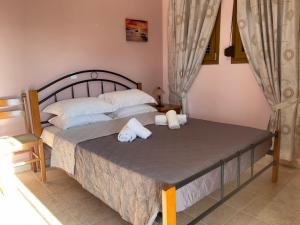 a bedroom with two beds with towels on them at VILLA ANTONIS in Kos