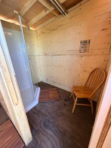an empty room with a chair in a cabin at Chief Mountain Cabins in Carway