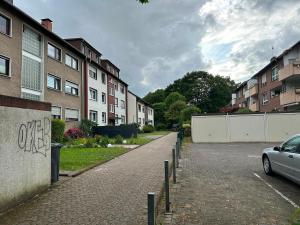 a car parked in a parking lot next to buildings at Green View - JK Apartments in Datteln