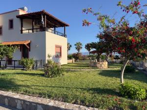 a house with a yard with a tree at VILLA ANTONIS in Kos