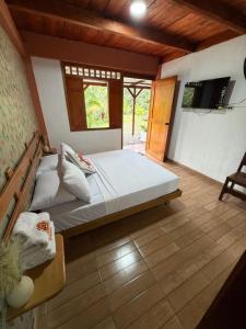 a bedroom with a large bed in a room at Finca Agroturística La pradera in Acacías +64 photos