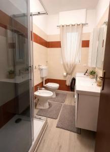 a bathroom with a toilet and a sink and a shower at Liam House - Stanza 1 in Limbiate
