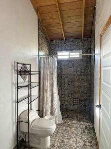 a bathroom with a toilet and a shower at #11- Rancho Meling in Camalú
