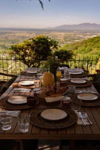 a wooden table with plates of food on it at Aura Toscana Boutique in Monsummano Terme