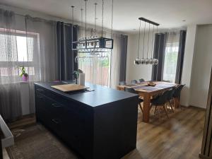 a kitchen with a black island and a dining room at Ferienwohnung Engel in Grebenstein +6 photos