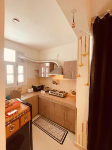 a kitchen with a stove and a counter top at Ra3sheesh Abode Comfort Connectivity and Charm in Dera Bassi