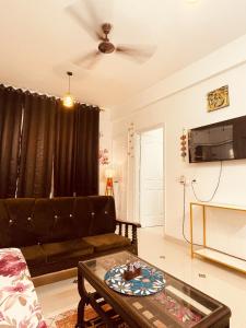 a living room with a couch and a coffee table at Ra3sheesh Abode Comfort Connectivity and Charm in Dera Bassi
