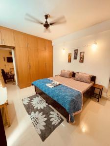 a bedroom with a bed and a ceiling fan at Ra3sheesh Abode Comfort Connectivity and Charm in Dera Bassi +13 photos