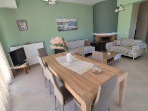 a living room with a wooden table and chairs at Seaside Vatera in Vatera
