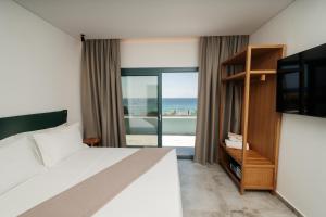 a bedroom with a bed and a view of the ocean at Villa Gonates in Limenaria +107 photos