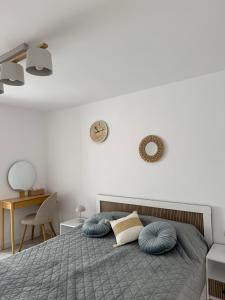 a bedroom with a bed with blue pillows on it at Nicola`s Apartment in Sozopol