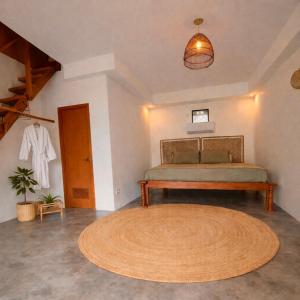 a bedroom with a bed and a large rug at Rodeo Sun Hotel in General Luna