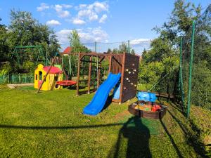 a playground with a slide and a swing set at DG EWA w Polańczyku in Polańczyk