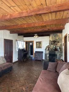 a living room with a couch and a stone fireplace at Casa Lizany in Camalú