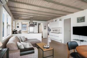 a living room with a couch and a table at LF15135-Farso-Strandvejen-35-B in Hvalpsund