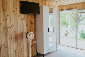 ein Zimmer mit einem Ventilator und einer Wand aus Holz in der Unterkunft COMPLEX AGREMENT BELLAVI in Ocna-Mureşului