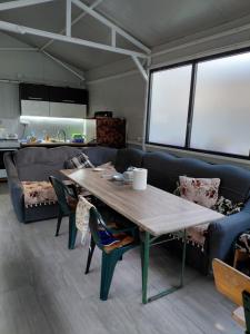 a living room with a table and a couch at Casa Mihai in Costinesti