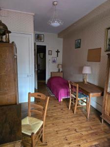 a bedroom with a bed and a table and chairs at Ma Guitoune in Grenoble
