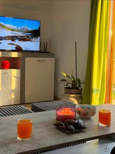a living room with a table with candles and a tv at ZELENI BOR koliba vikendica Pale in Pale