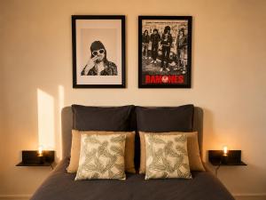 a bedroom with three pictures on the wall above a bed at Appart T3 Stratégique - Parking - Accès A64 in Portet-sur-Garonne +7 photos
