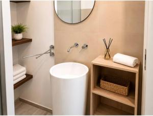 a bathroom with a white sink and a mirror at La Via Per Erice in Casa Santa