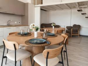 a kitchen and dining room with a wooden table and chairs at La Via Per Erice in Casa Santa +11 photos